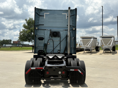 Back view of a Volvo VNL64T760 truck tractor showing rear chassis and fifth wheel with dual rear axles.