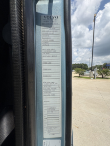 Volvo VNL64T760 truck door jamb label with multiple specification blocks and VIN sticker visible.