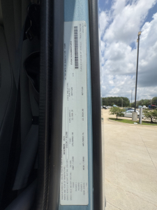 Truck door jamb label showing VIN and vehicle specs on 2022 Volvo VNL64T760 used conventional sleeper. Visible text includes VIN 4V4NC9EH6NN605493 and other details on a white sticker.