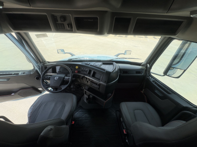 Volvo VNL64T760 truck interior showing steering wheel and dashboard with seats visible.