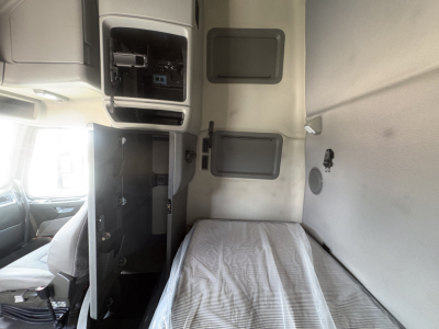 Cab interior of a 2022 Volvo VNL64T760 sleeper showing bunk bed with mattress and side compartments; dashboard area and storage panels visible.