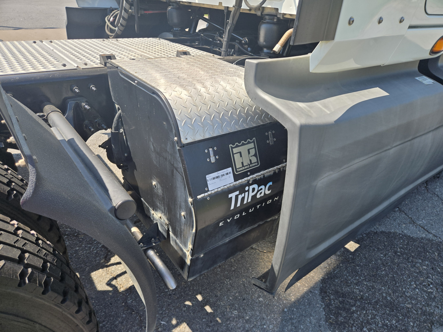Truck cab area showing TiPaC Evolution battery cover and diamond plate step in view.