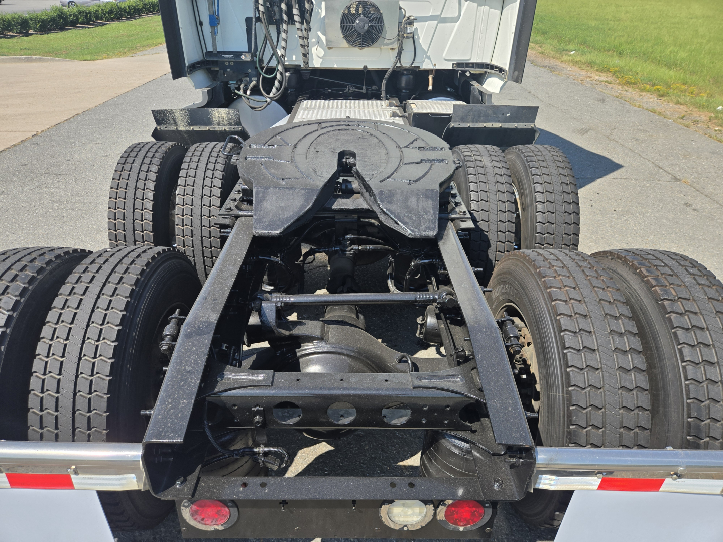 Truck chassis and rear view showing fifth-wheel, dual rear axles, and suspension on a 2021 International LT625 truck.