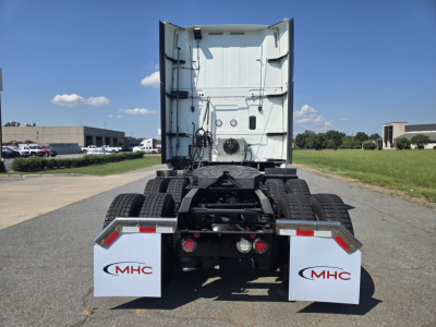 Truck rear view showing fifth wheel and dual rear axles on a 2021 International LT625 tractor with MHC mud flaps.