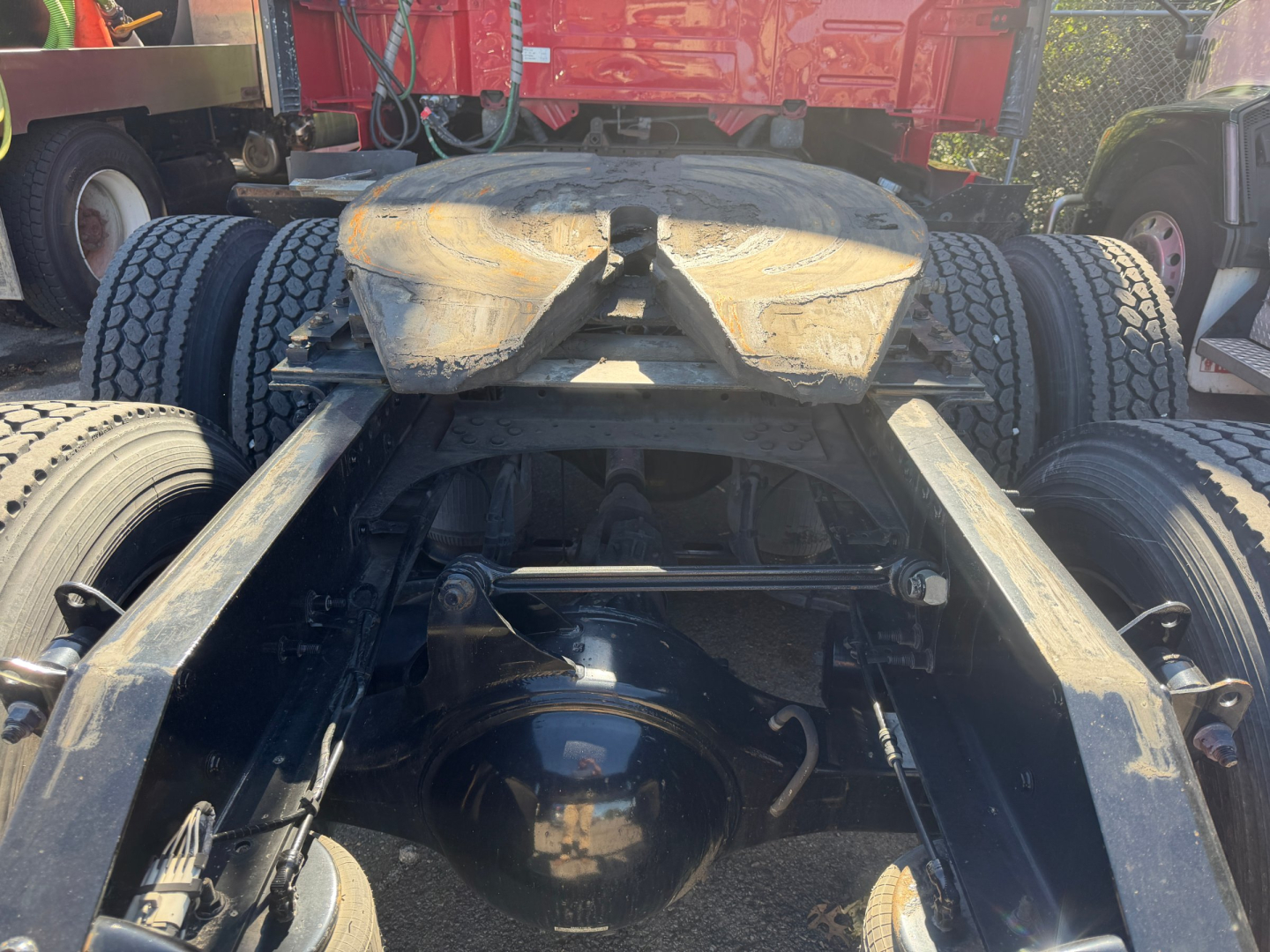 Rear view of a Volvo VNL64T760 tractor chassis showing rear axles, fifth-wheel, and suspension components.