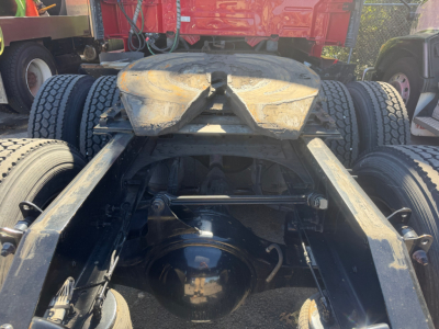 Rear view of a Volvo VNL64T760 tractor chassis showing rear axles, fifth-wheel, and suspension components.