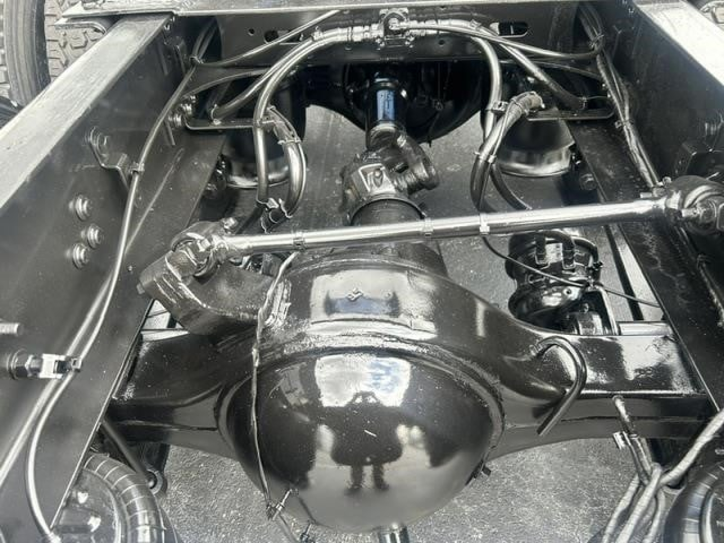 Rear-view of Freightliner Cascadia 126 chassis showing differential housing and drivetrain components with suspension and linkage visible.