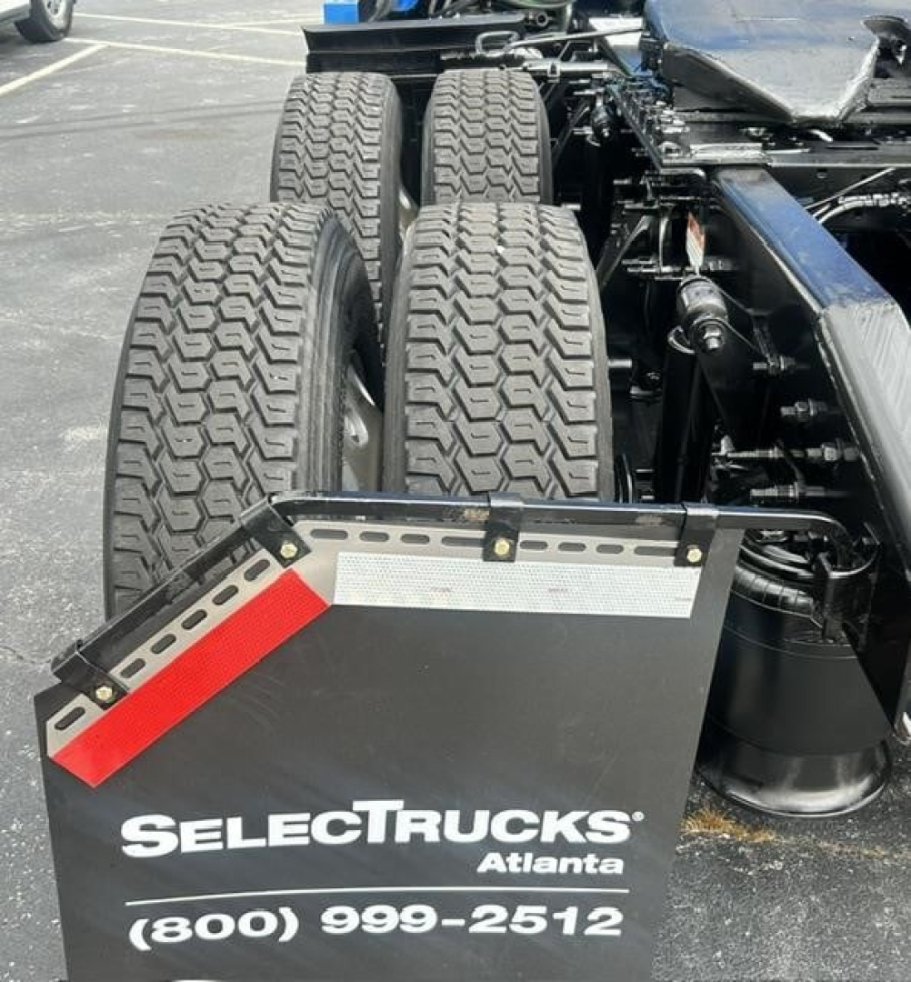 Freightliner Cascadia 126 truck rear dual tires and fifth wheel area with SelectTrucks Atlanta sign and contact number.