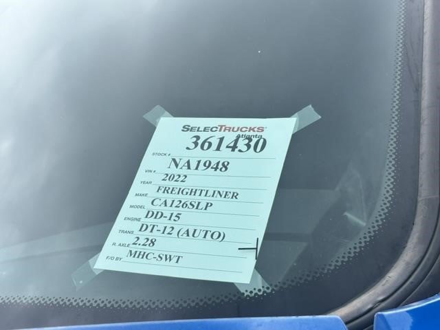 Tag on windshield showing stock number 361430, NA1948, 2022 Freightliner Casadia, model CA126SLP, DD-15 (AUTO) engine, DT-12 (Auto) transmission.