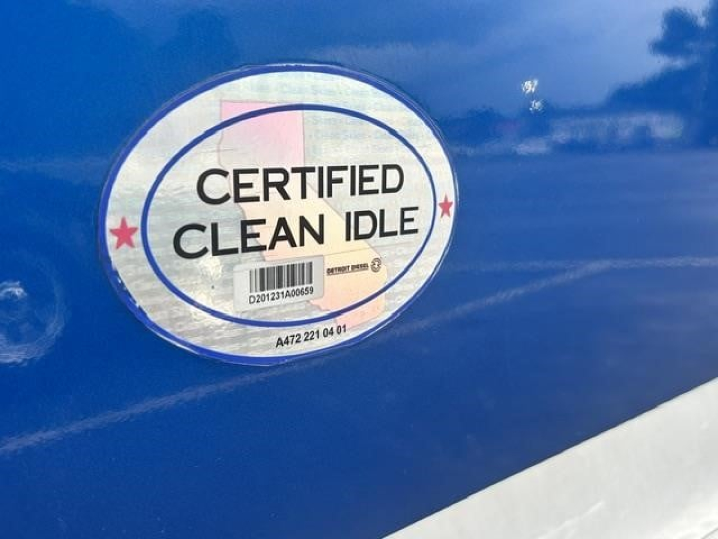 Truck exterior badge reading CERTIFIED CLEAN IDLE on blue surface.