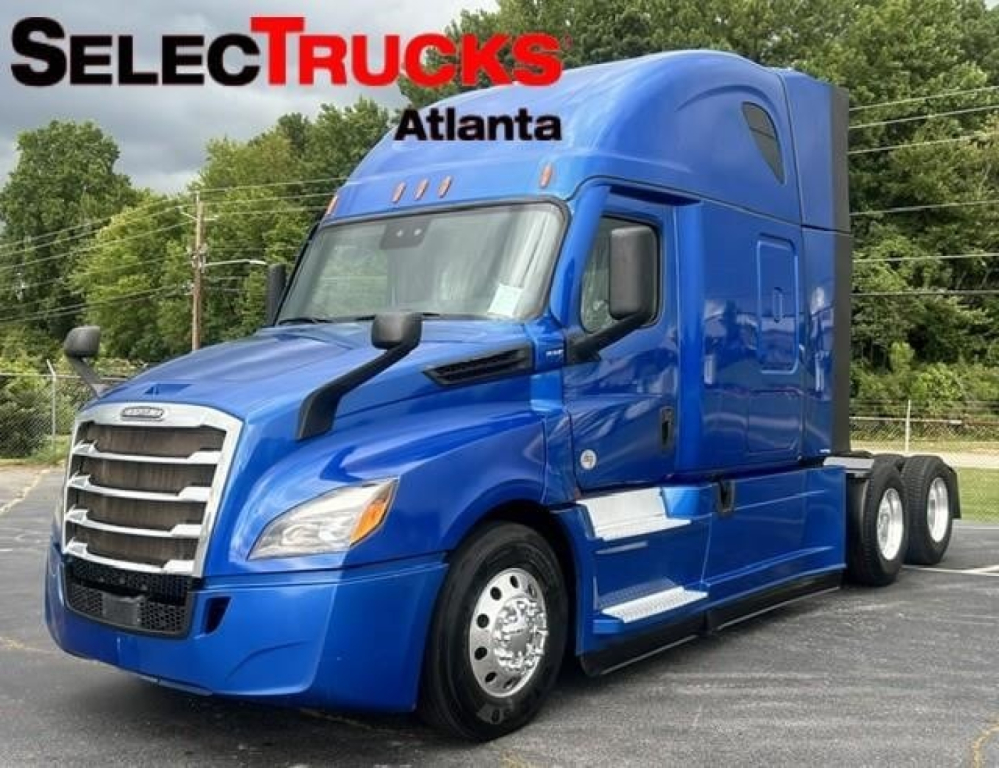 Blue Freightliner Cascadia 126 truck in side view with SelectTrucks Atlanta logo. Visible text: SELECTTRUCKS ATLANTA on image.