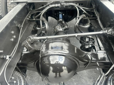 Rear-view of Freightliner Cascadia 126 chassis showing differential housing and drivetrain components with suspension and linkage visible.