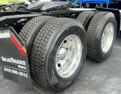 Freightliner Cascadia 126 rear dual wheels showing tires and chassis with SelectTrucks Atlanta sign in the mud flap.