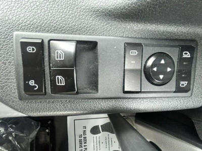 Freightliner Cascadia control panel showing window switches, mirror adjustment pad, and lock buttons.