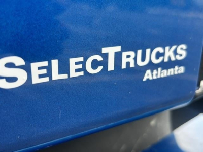 Selective Trucks Atlanta branding on blue truck part visible.