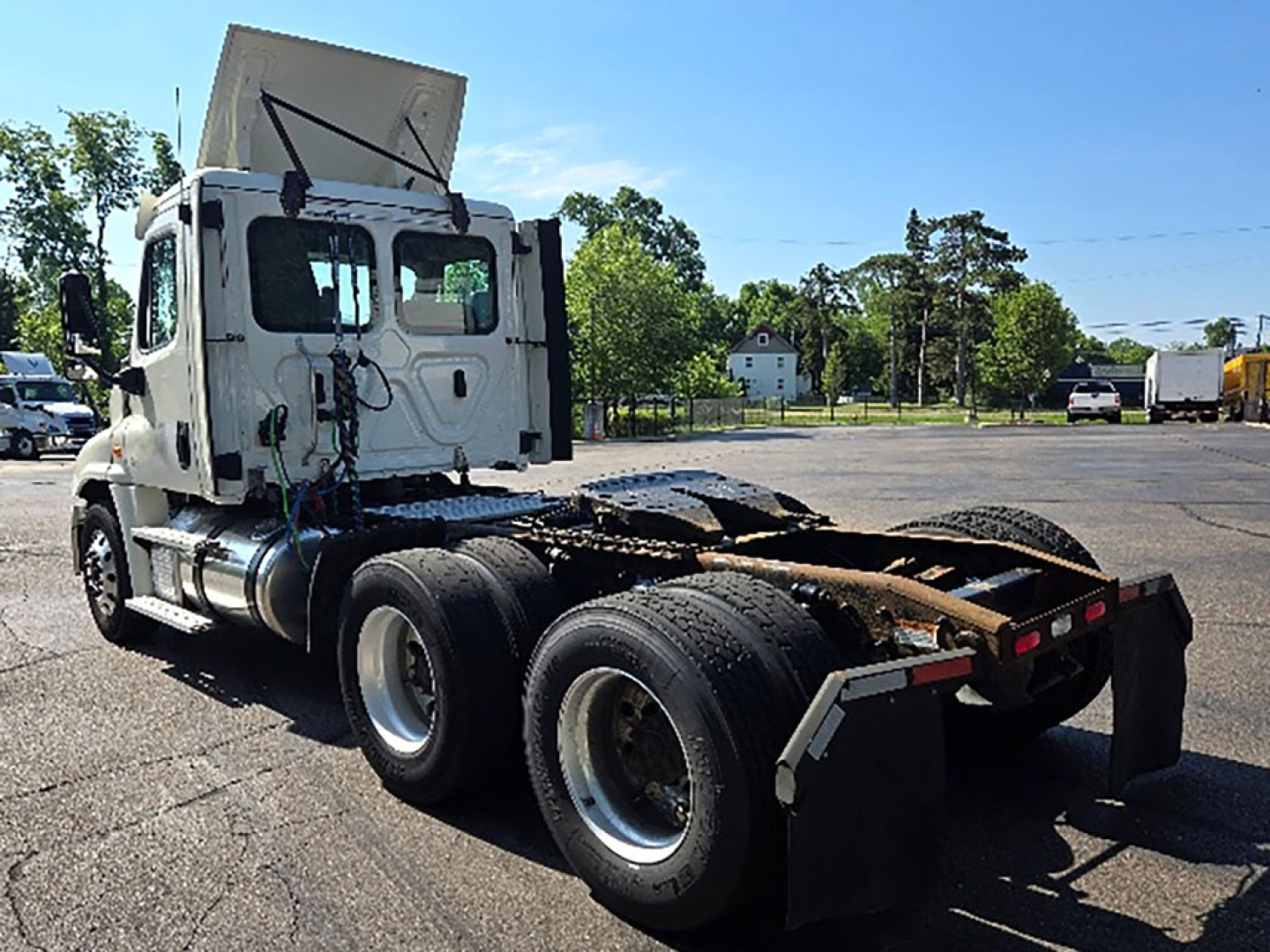 Tractor unit of a Freightliner Cascadia125 truck shown from rear-left, horizontal fifth wheel and dual rear axles visible.