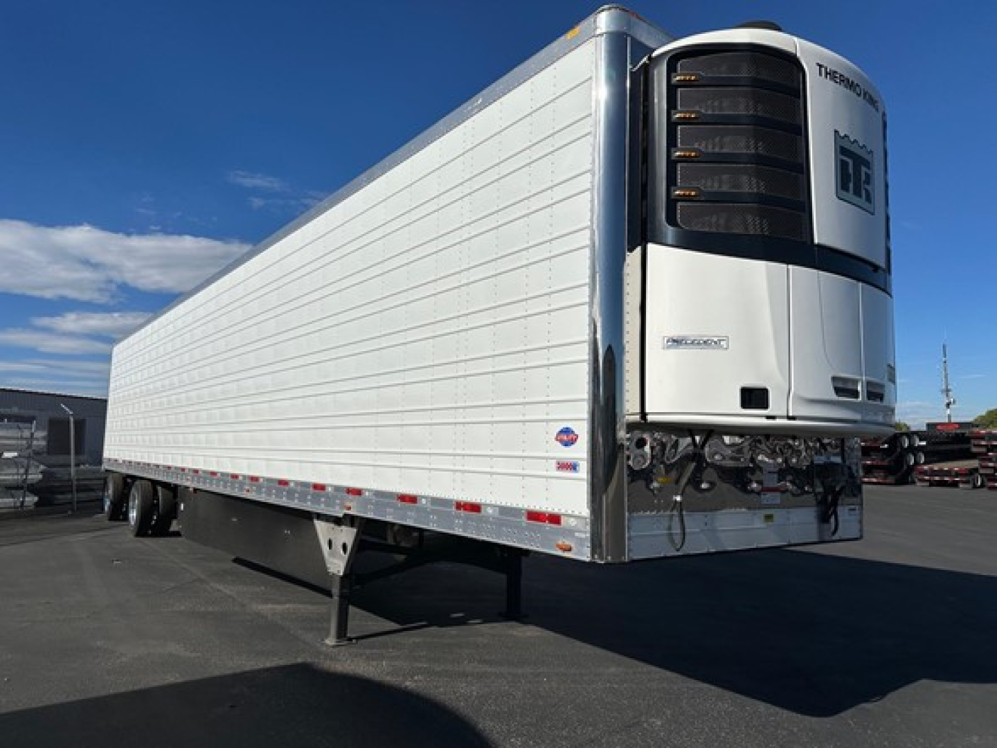 Reefer trailer from front-right showing Thermo King reefer unit with DR power and side of trailer. No visible text other than Thermo King logo on unit.