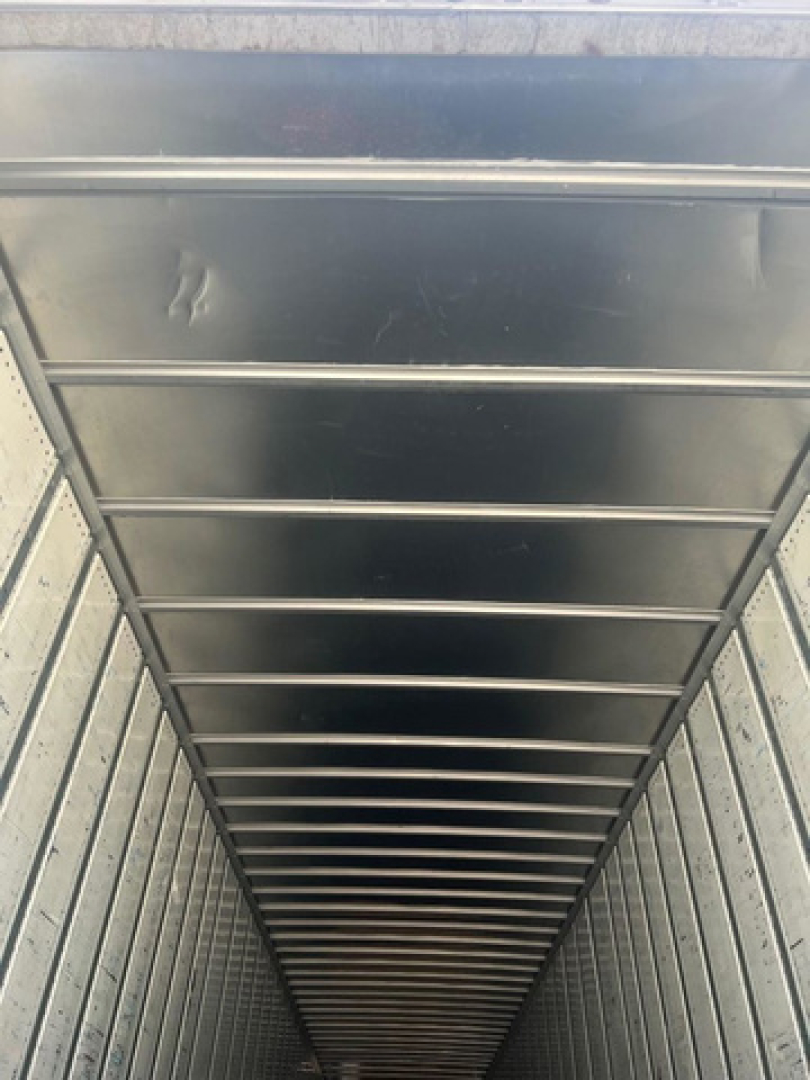 Inside view of a utility van showing overhead ribbed ceiling and interior walls