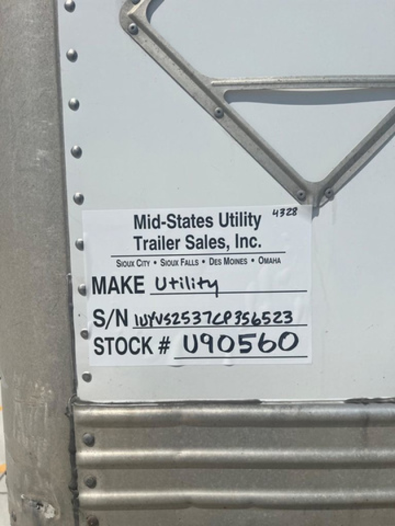 Mid-States Utility Trailer Sales label on trailer showing MAKE Utility and S/N 1UYVS2537CP356523 and STOCK # U90560.