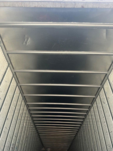 Inside view of a utility van showing overhead ribbed ceiling and interior walls