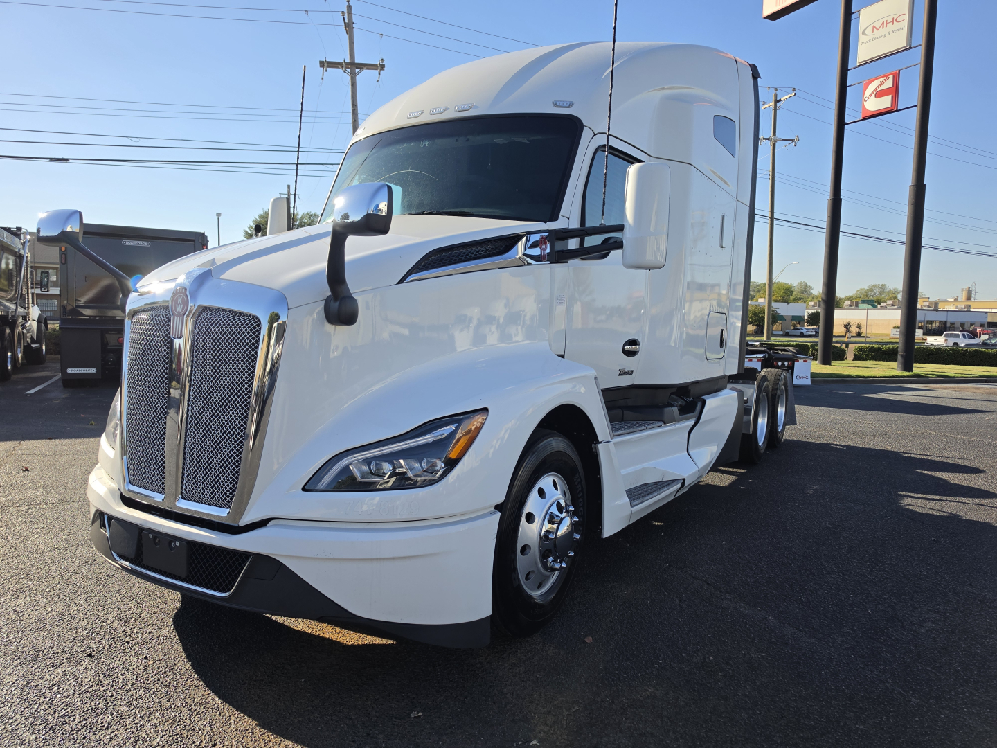 Kenworth T680 conventional sleeper truck in white, front-left view with large grille and sleeper cab.