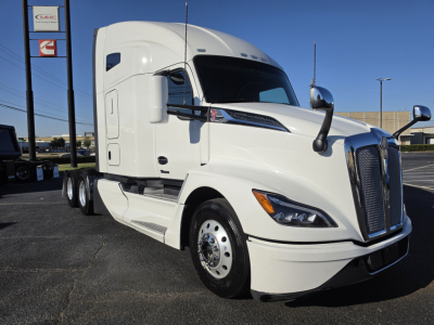 Kenworth T680 tractor-trailer in white, front-left view showing aerodynamic cab, large grille, dual mirrors, and steps; no visible text on the truck.