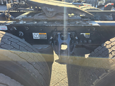 Kenworth T680 undercarriage showing rear chassis, suspension, and drive axle area with tires and frame components.