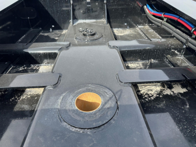 Load King 55 Ton Lowboy trailer hitch area showing central kingpin receptacle and surrounding frame components.
