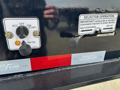 Load King lowboy trailer control panel showing ignition switch and selector operation label.