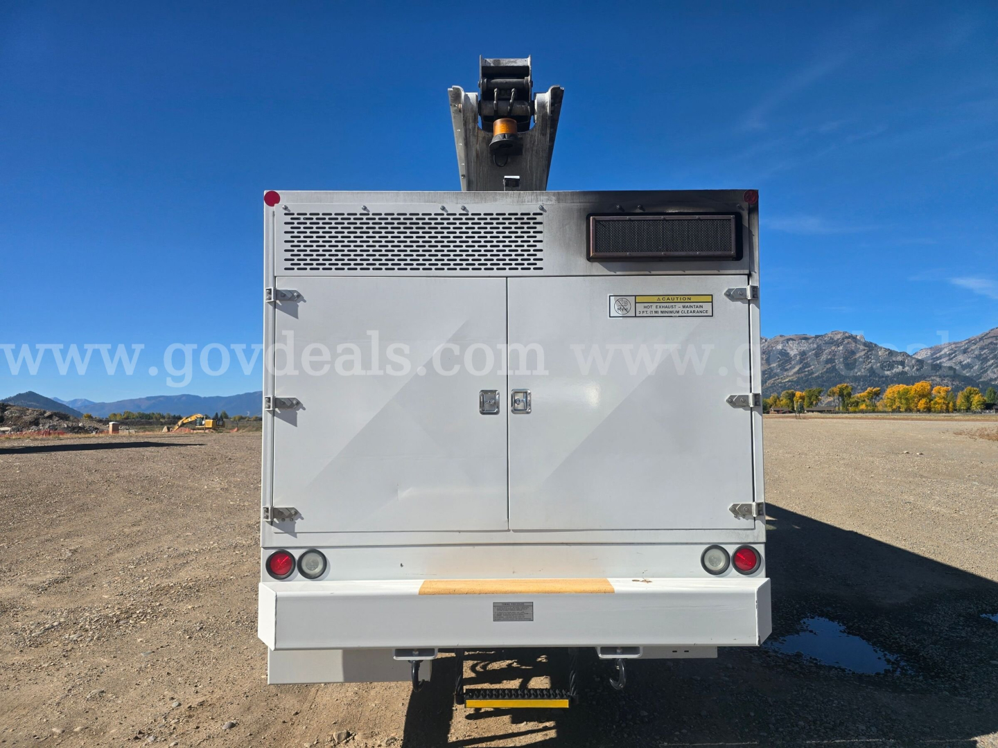 Rear view of Freightliner truck body showing storage compartments and lighting, no visible text.