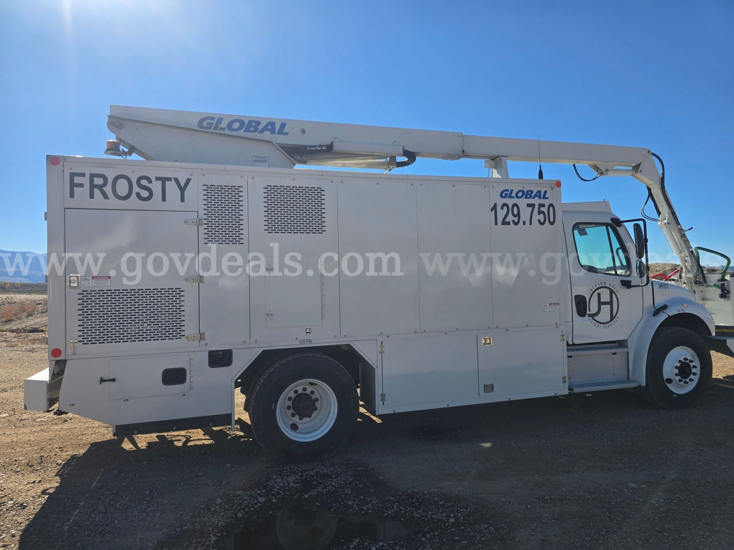 Truck maintenance vehicle with a large side label 'FROSTY' and a Global boom arm; side panel with vent grids and '[Global] 129.750' visible near cab; front wheel and door area; watermarked listing site text across the middle.