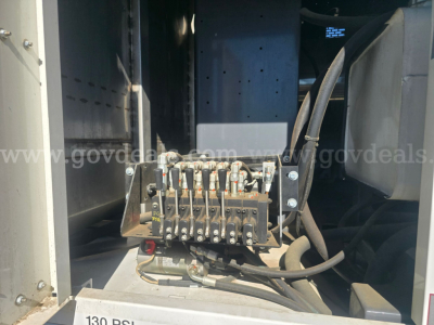 Electrical control block with multiple connectors and wiring mounted inside a Freightliner chassis compartment.