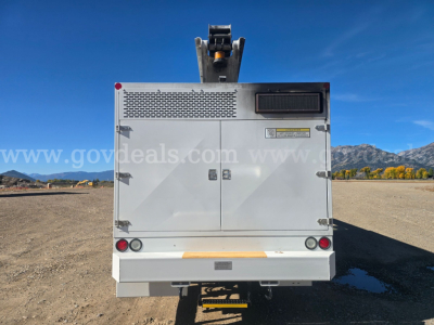 Rear view of Freightliner truck body showing storage compartments and lighting, no visible text.