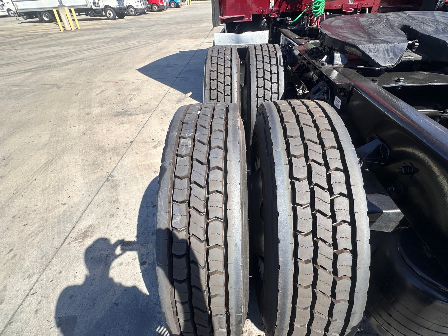 Triple rear wheels/tires on a Kenworth T680 chassis showing tread pattern and axle area