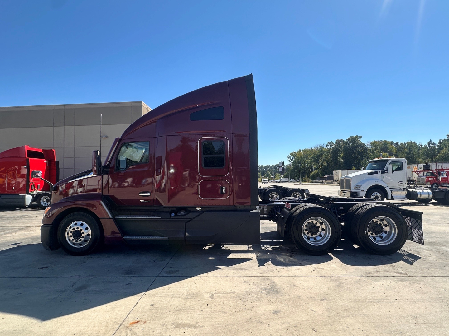 Kenworth T680 tractor cab side profile in burgundy, chassis behind with dual rear axles, stock number 0632214.