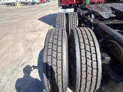 Triple rear wheels/tires on a Kenworth T680 chassis showing tread pattern and axle area