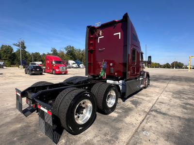 Kenworth T680 rear/side view showing the back of cab and dual rear axles with fifth-wheel and mudflaps. No visible serials or labels legible.