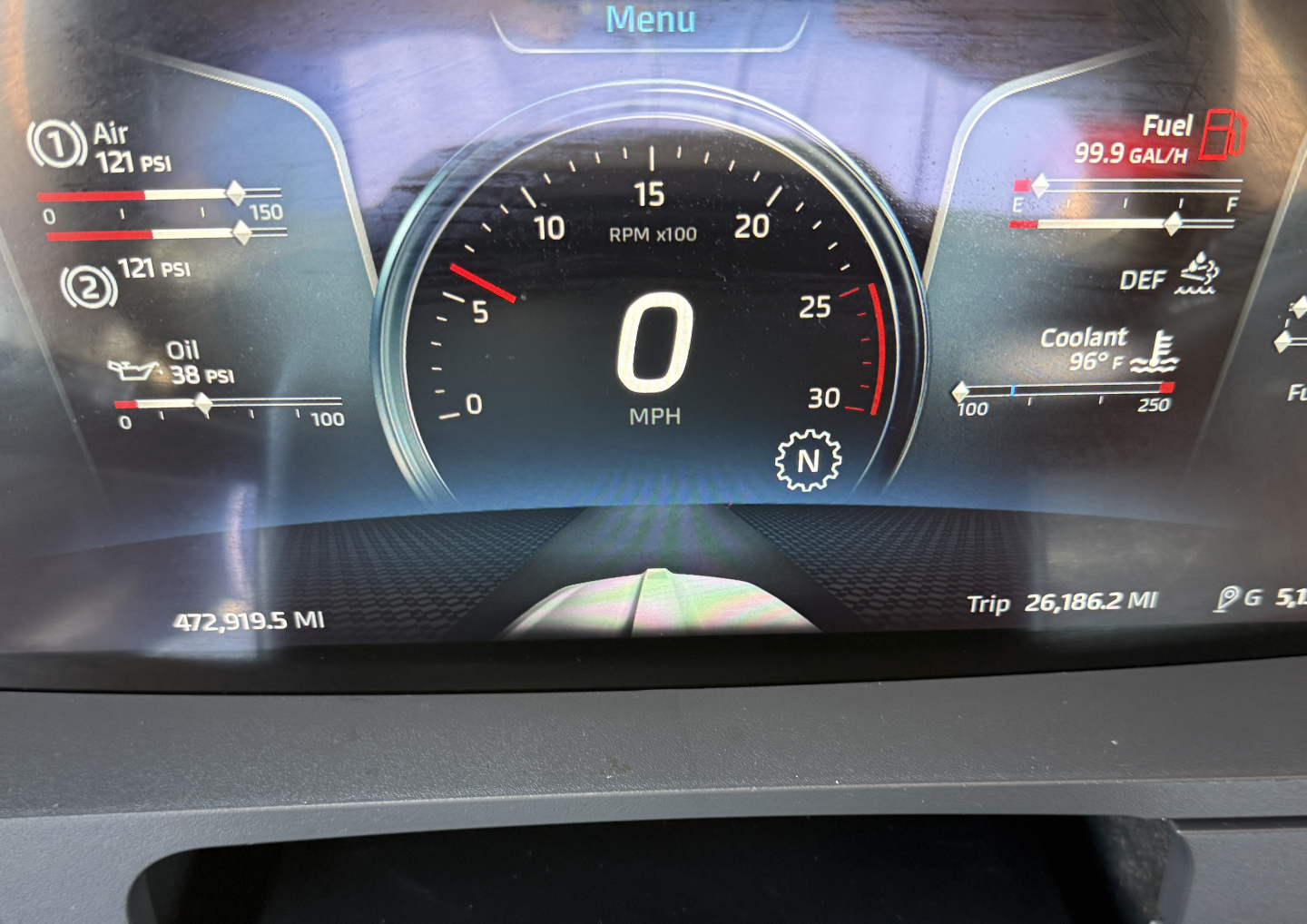 Dashboard view of a 2023 Kenworth T680 showing digital gauge cluster with speedometer at 0 MPH, fuel gauge, DEF indicator, coolant temp, oil pressure, and trip/odometer readings.