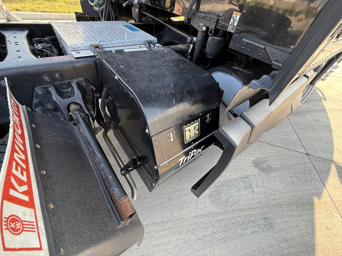 Kenworth T680 truck chassis showing toolbox and steps with RK logo and black metal components.