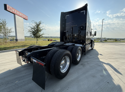 Kenworth truck chassis rear and sleeper cab view showing dual rear axles and fifth wheel mounting, with no visible text on components.