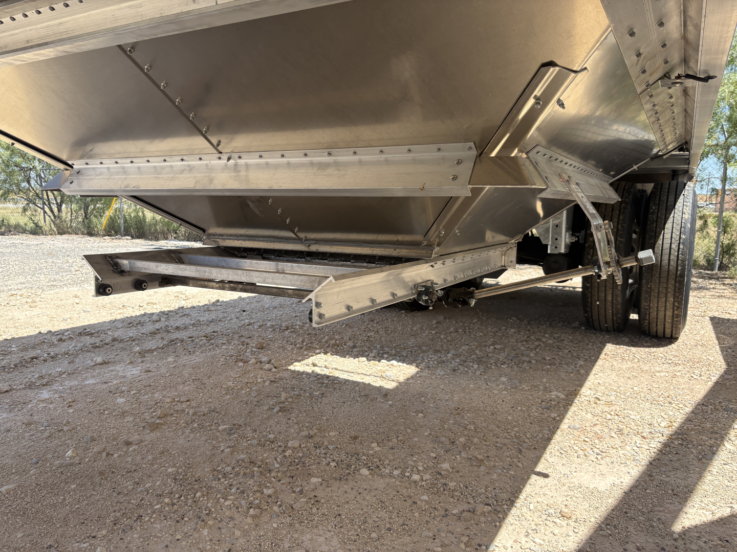 55_D-327-1: Trailer underside view showing steel hopper with 74" corrugated sidewalls, hinge mechanism, and trailer axle wheels visible.