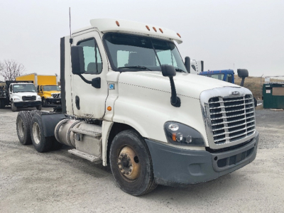 Freightliner Cascadia125 truck shown in a yard, side view with front grille and dual rear axles visible.