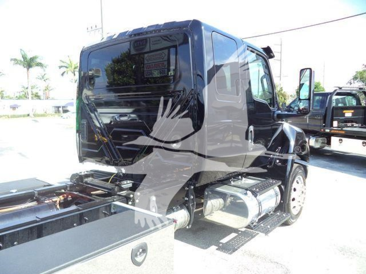 Truck cab (MVEXCABBLKSHRKFM) in new condition, side view showing fuel tanks and rear exposed hitch area.