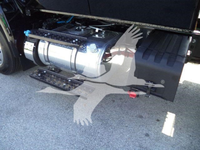 Truck fuel tank and side compartment visible under a 2027 International MV cab with rollover equipment.