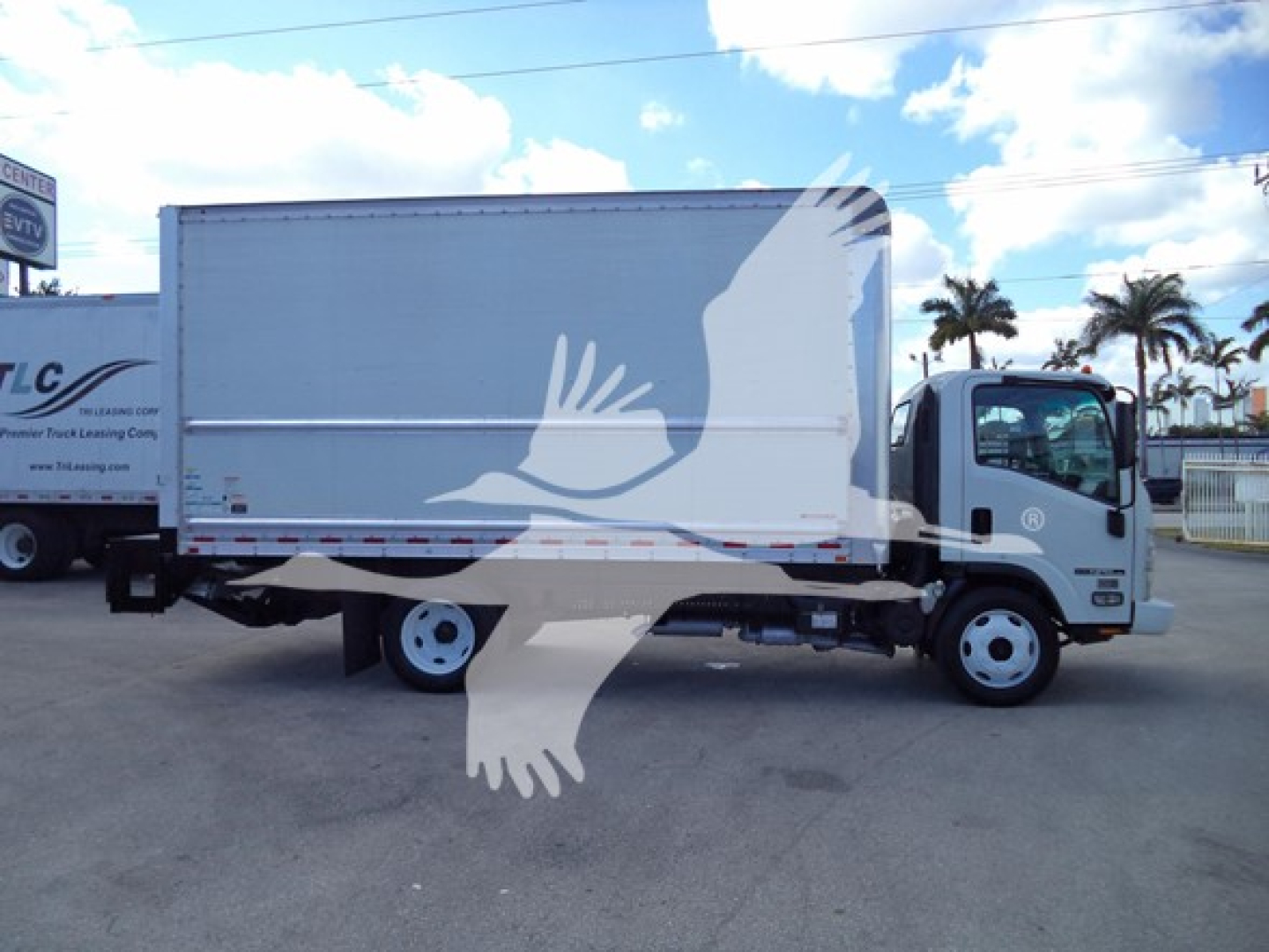 Isuzu NPR HD medium-duty box truck in side view with white cargo box and cab.