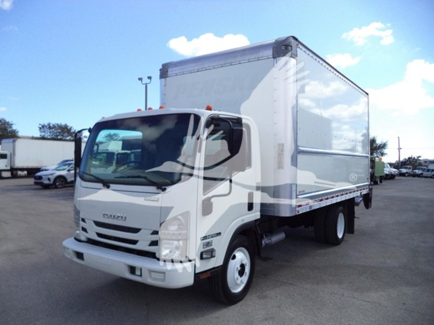 Isuzu NPR HD box truck in view showing cab and cargo box with stock number T00728 and VIN label present