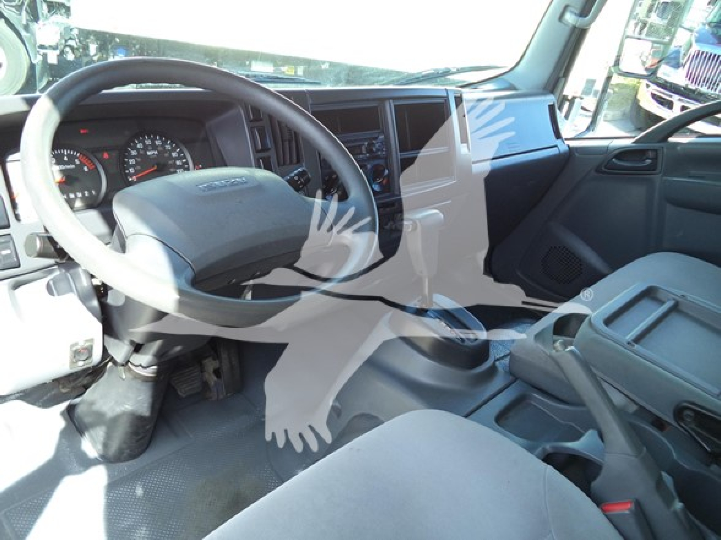 Isuzu NPR HD truck interior showing steering wheel and dashboard with center console.