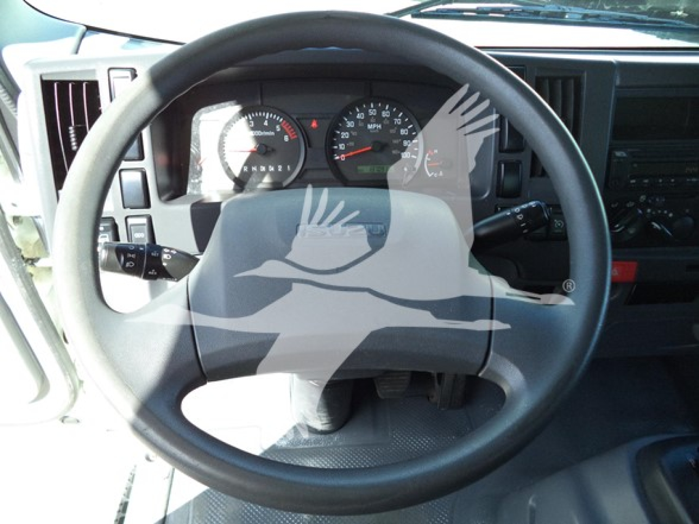 Isuzu NPR-HD truck interior steering wheel and dashboard with gauges visible