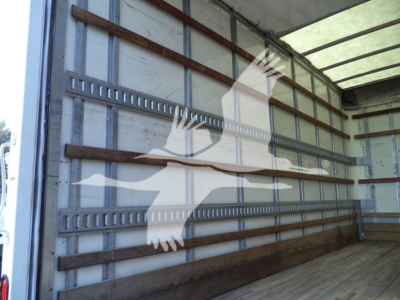 Inside view of a box truck cargo area with striped wooden side rails and metal track slats.