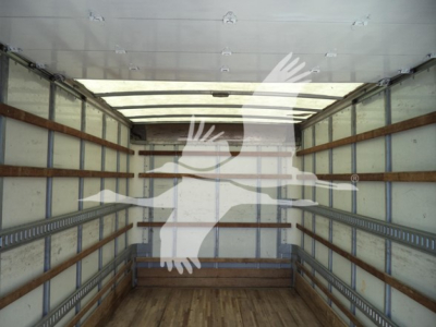 Isuzu NPR HD box truck interior showing empty cargo area with wooden floor and metal side rails.